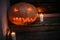 Happy Halloween. Halloween street decor with spooky Jack-o`-lantern. Pumpkin with scary carved glowing face and candle light in