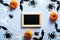 Happy halloween holiday concept. Halloween decorations, picture frame, spiders, bats, ghosts, pumpkins on blue background. Flat