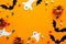 Happy halloween holiday concept. Halloween decorations, pumpkins, bats, candy, ghosts, bugs on orange background. Halloween party