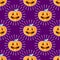 Happy Halloween jackolantern seamless pattern. Jack lantern pumpkin with rays. Vector illustration isolated on purple