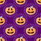 Happy Halloween jackolantern seamless pattern. Jack lantern with rays. Vector illustration isolated on purple background