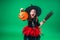 Happy Halloween! little girl in a black hat and witch costume with a broom