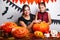 Happy Halloween. Mother and daughter carving pumpkin. Family preparing for holiday.