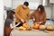 Happy Halloween. Mother, father and their daughter carve a pumpkin. Happy family is preparing for Halloween