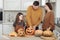 Happy Halloween. Mother, father and their daughter carve a pumpkin. Happy family is preparing for Halloween