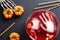 Happy Halloween party flat lay composition. Halloween decorations, bowl of bloody color drink, frozen hands, pumpkins, drinking