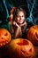 Happy halloween. Pretty little child girl in witch costume with carving pumpkin . Happy family preparing for Halloween.