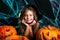 Happy halloween. Pretty little child girl in witch costume with carving pumpkin . Happy family preparing for Halloween.