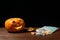 Happy Halloween pumpkin and candies. Trick or treat on a wooden table on a background of old wooden boards