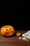 Happy Halloween pumpkin and candies. Trick or treat on a wooden table on a background of old wooden boards