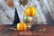 Happy Halloween, pumpkins, mortar, healing plants, witch hat and dry branches on sunset background, composition