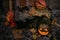 Happy Halloween. Spooky Jack-o`-lantern with glowing faces and cobweb in dark. Pumpkin with scary carved face on hay with candle