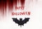 Happy Halloween text. Bat on bloody background.