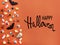 Happy Halloween text. Decorations and candy on orange background