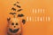 Happy Halloween text, greeting card. Pumpkin with face and black bats, ghost, spider paper decorations on orange background. Flat