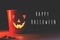 Happy Halloween text, greeting card. Spooky atmospheric jack o lantern face glowing pumpkin in dark. Trick or treat. Halloween