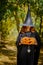 Happy halloween witch girl keeps pumpkin