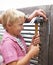 Happy, hammer and boy kid doing maintenance on wood gate for fun or learning. Smile, equipment and young child looking