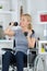 Happy handicapped person on wheelchair with dumbbell