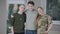 Happy handsome man posing with military mother in uniform and father indoors. Portrait of smiling positive Caucasian