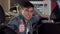 Happy handsome man showing thumbs up, sitting in a new car at the dealership