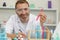 Happy handsome smiling mature man in white laboratory coat