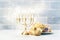 Happy Hanukkah background with menorah, burning candles and donu