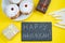 Happy Hanukkah. Jewish dessert Sufganiyot on yellow background. Symbols of religious Judaism holiday. Donuts, candles