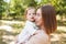 Happy harmonious family outdoors. mother with her baby, playing in the summer on the nature