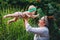 Happy harmonious family outdoors. mother throws baby up, laughing and playing in the summer on the nature.