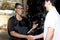 Happy harmony people at workplace, smiling guy making handshake with partner African American woman who working together at auto