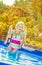 Happy healthy child in swimwear standing in swimming pool