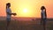 Happy healthy kids playing with a ball on a green meadow at sunset. happy family and childhood concept. teenage girls