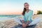 Happy healthy lifestyle yoga girl stretching legs exercise on morning fitness training. Asian woman smiling on beach