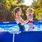 Happy healthy mother and child in swimming pool playing