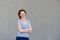 Happy healthy older woman standing by wall outside