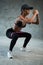 Happy healthy smiling woman working out with resistance band at the gym