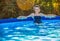 Happy healthy woman in blue swimwear in swimming pool relaxing