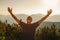 Happy hiker enjoying his travel, while he stands on the top of