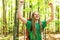 Happy hiker raising his hands in the air