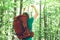 Happy hiker raising his hands in the air