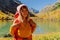 Happy hiker woman at mountains lake in autumnal season