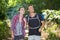 Happy hikers looking up while standing in forest