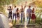 Happy hikers with raised arms enjoying the beauty of nature