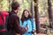 Happy hikers talking on forest hike outdoors