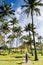 Happy hipster gitl walking bitween palm trees on Anakena beach, Easter Island