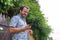 Happy hipster smiling, using smart phone, with good mood and confidence, reading news with wifi. Joy handsome dude out his door