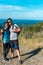 A happy Hispanic couple on a walk in the mountains, standing together