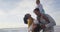 Happy hispanic family having fun on beach at sunset