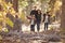 Happy Hispanic family with two children walking in a forest